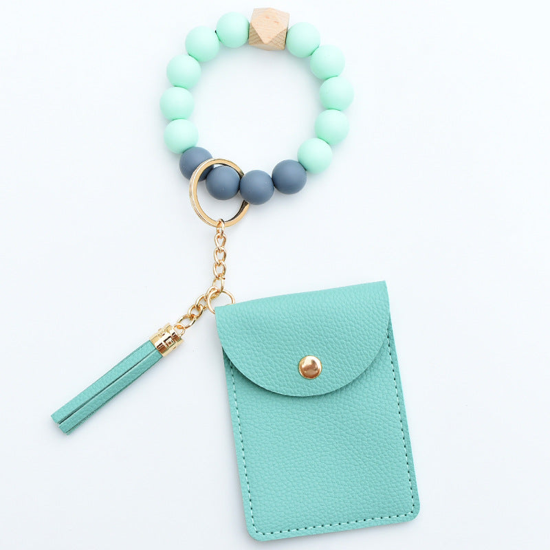 Comercio al por mayor Cuentas de silicona PU Titular de la tarjeta de color sólido Llavero de muñeca